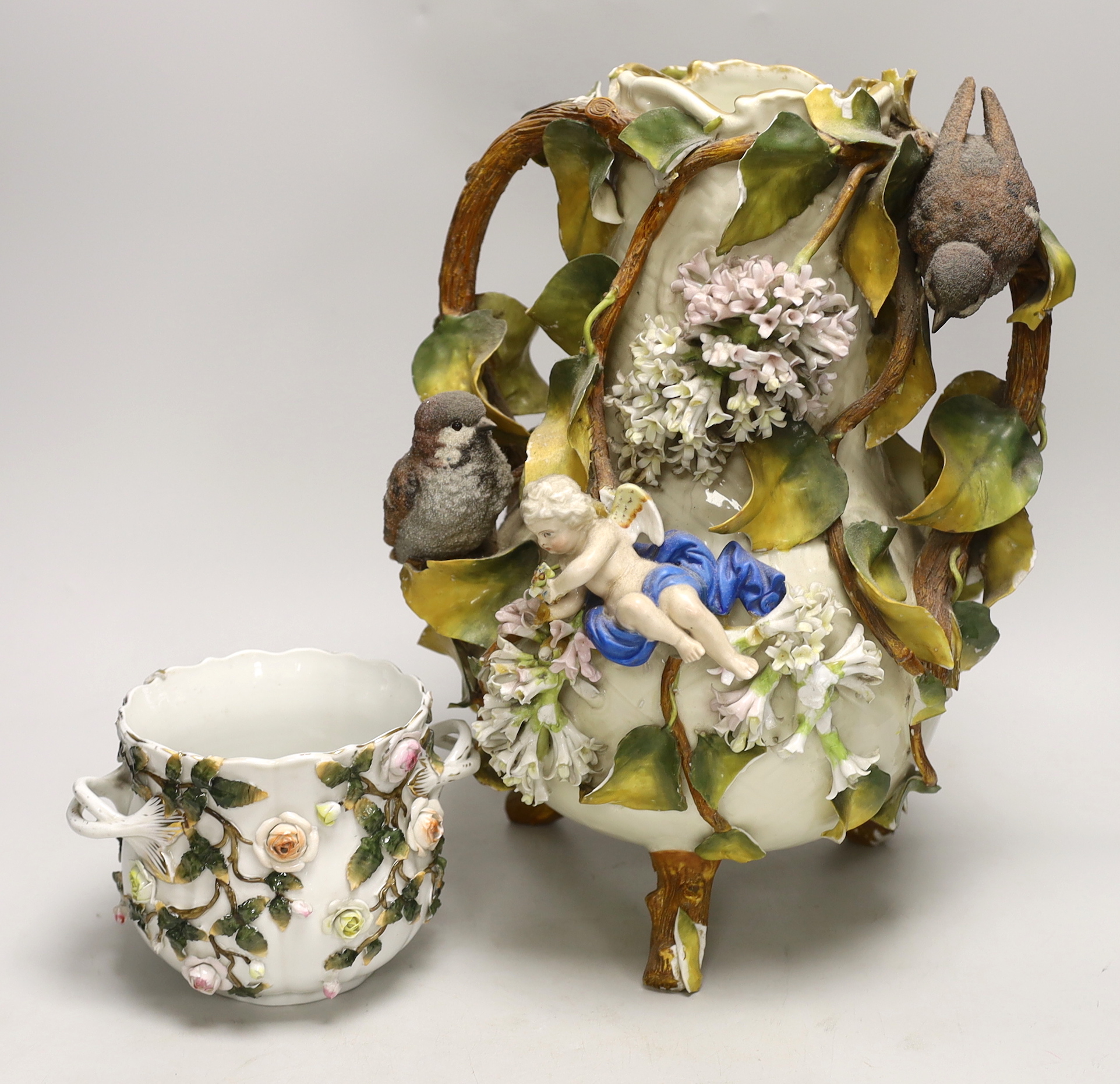 A large Sitzendorf porcelain vase modelled with putti and sparrows and a similar flower encrusted bowl, vase 37cm (2)